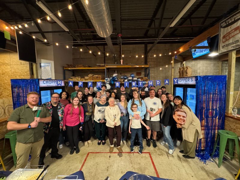 A group celebrating a birthday and throwing axes at Chopper's Hatchet House